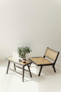 laptop on a table with chair and plant